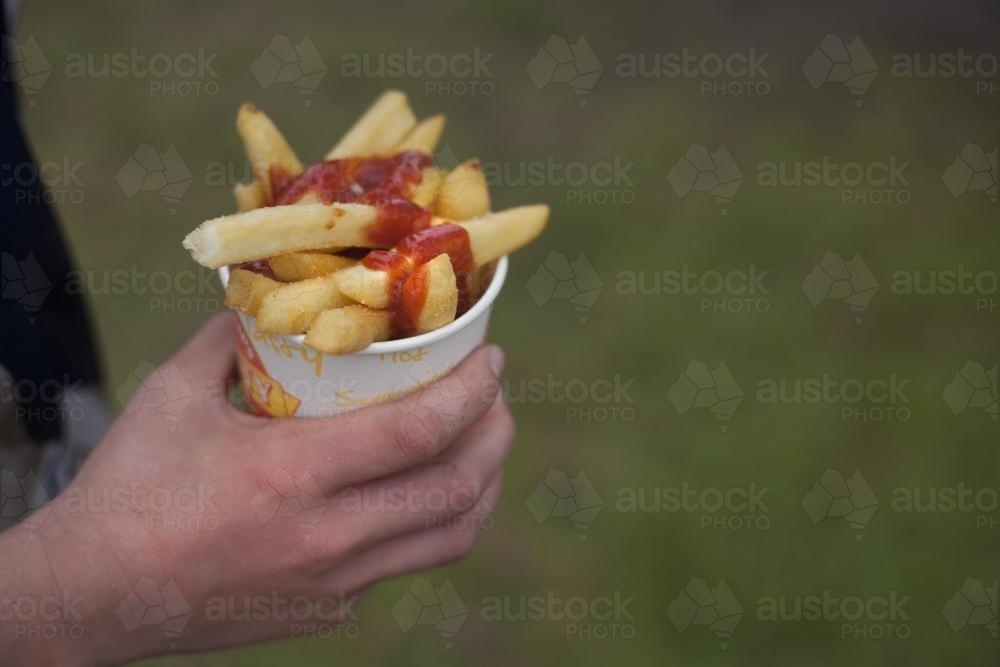 Bucket of chips with sauce - Australian Stock Image
