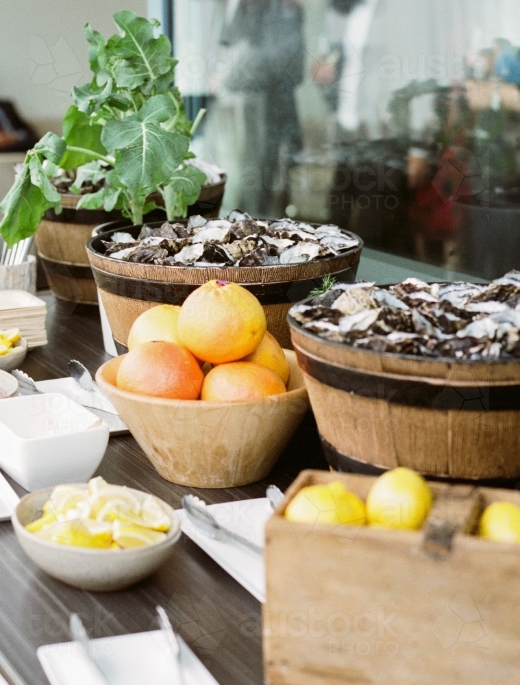 Buckets of oysters and lemons at a wedding - Australian Stock Image