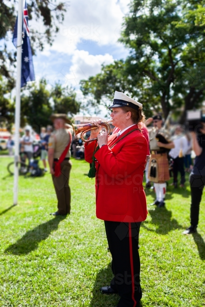 Image of Bugle player playing at ANZAC day memorial service - Austockphoto