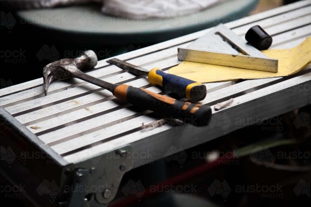 Builders tools and hammer lying on construction site - Australian Stock Image