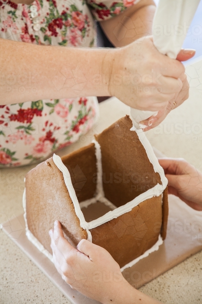 Building a gingerbread house for Christmas - Australian Stock Image