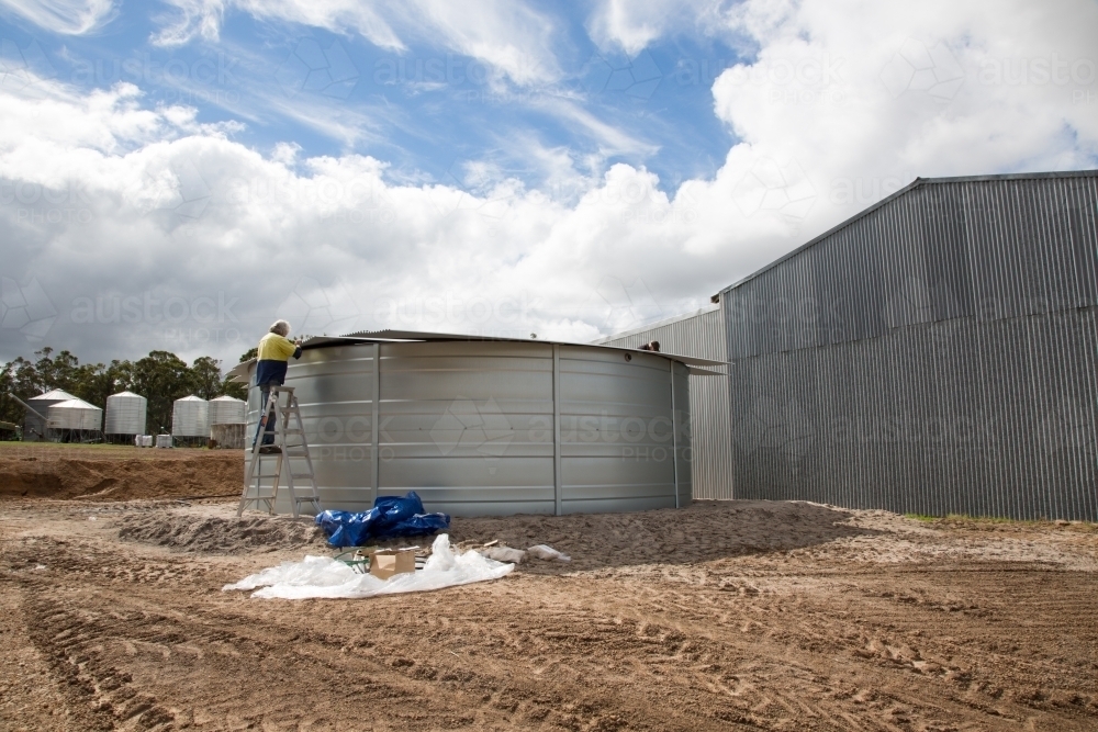 Building a steel tank for farm water supply - Australian Stock Image