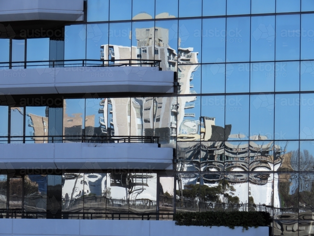 Building reflection on glass with blue sky - Australian Stock Image