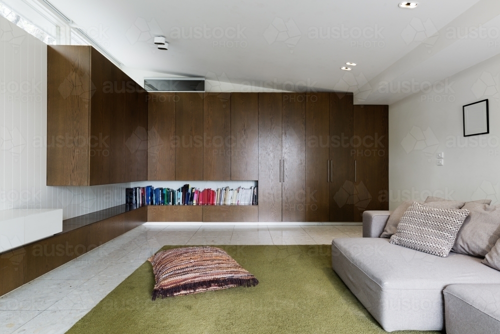 Built in walnut veneer cabinetry in modern living room interior - Australian Stock Image