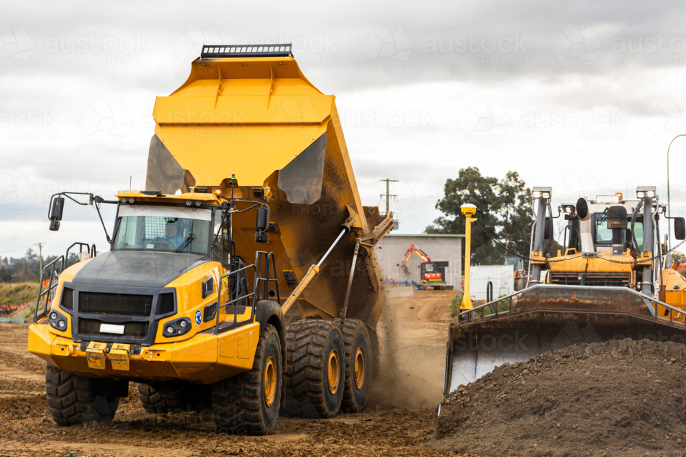 bulldozer and dump truck on construction site with earthworks building Singleton bypass - Australian Stock Image