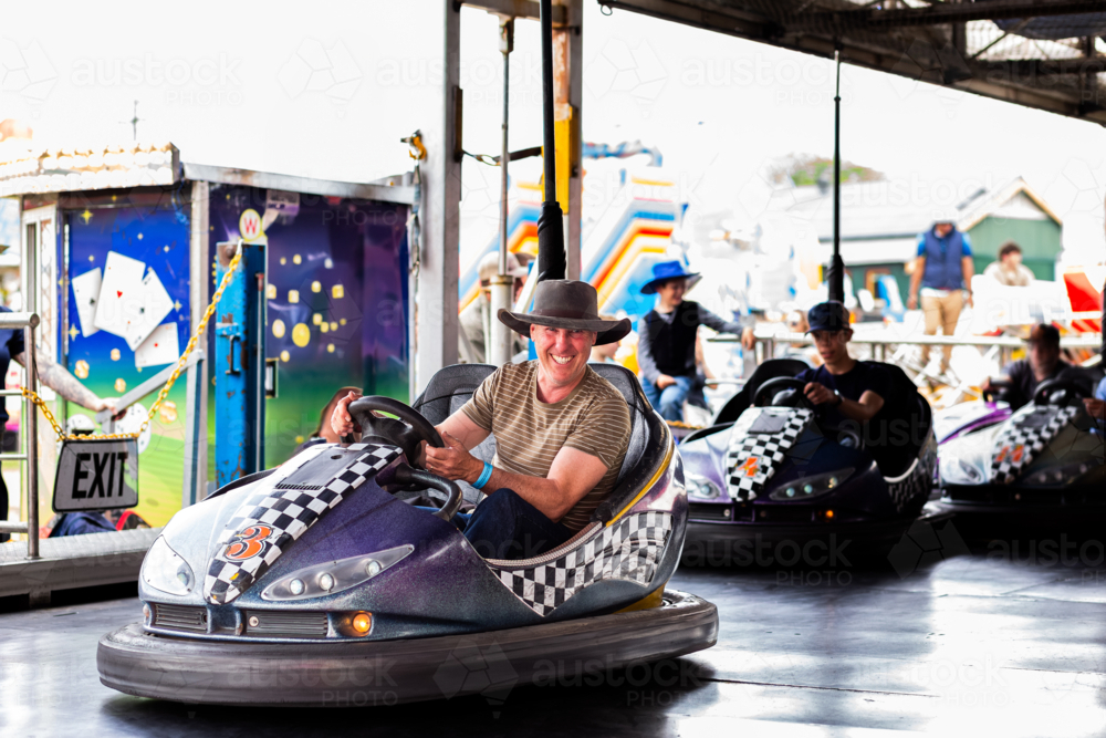Image of Bumper cars ride with Aussie man riding dodgem car at carnival ...