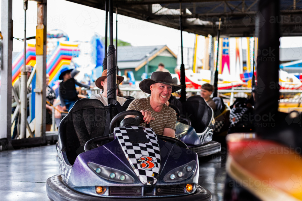 Image of Bumper cars ride with Aussie man riding dodgem car at carnival ...