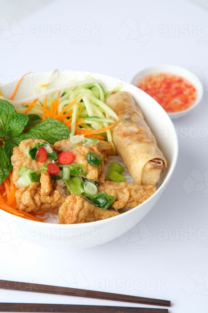Image of Bun Cha Gio bowl topped with fried spring roll and Cha Lua ...