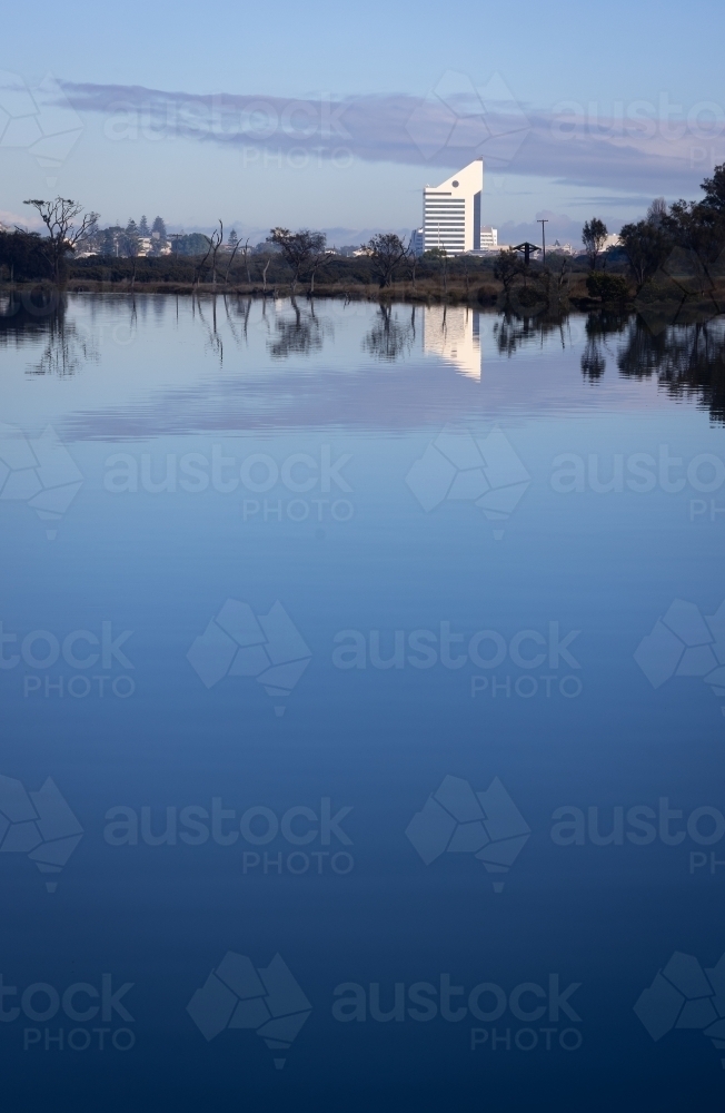 Bunbury skyline in the distance with still blue water of the inlet in foreground - Australian Stock Image