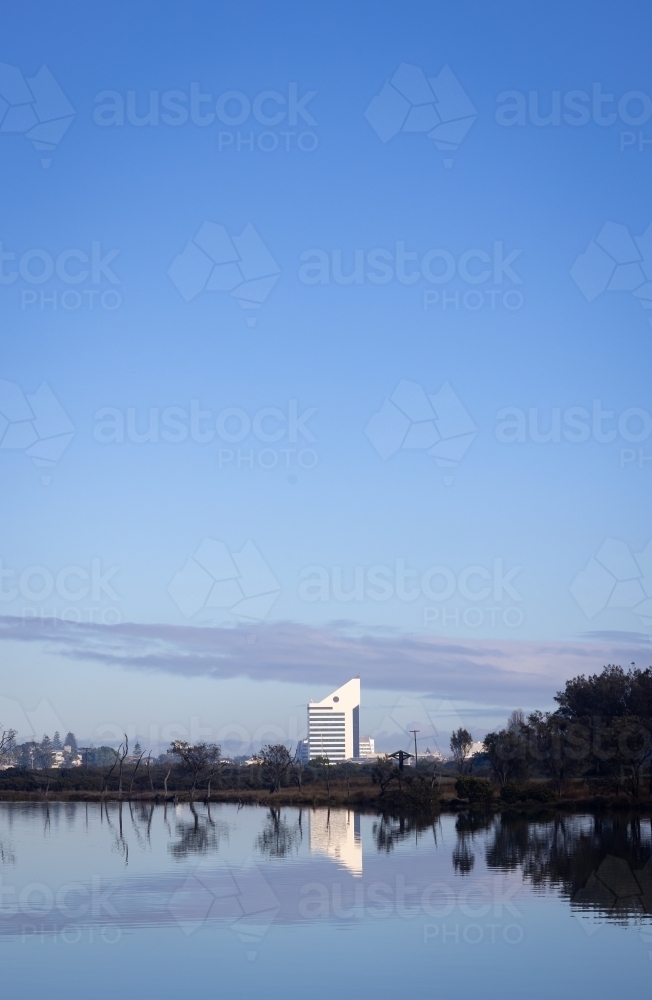 Bunbury skyline in the distance with still blue water of the inlet in foreground - Australian Stock Image