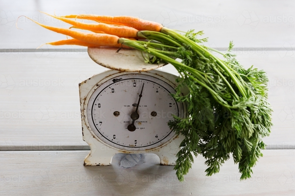 Bunch of carrots on a vintage set of scales - Australian Stock Image