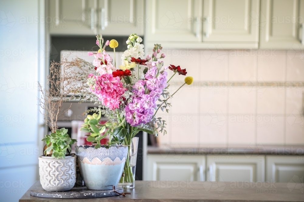 Bunch of cottage flowers on display in country kitchen - Australian Stock Image