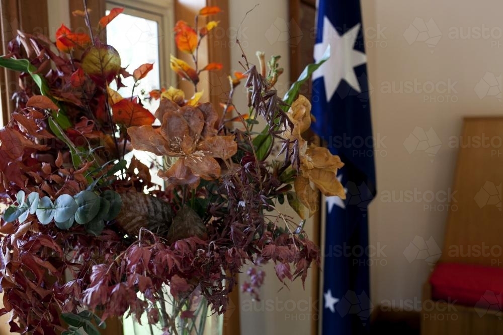 Bunch of flowers with Australian flag hanging in background - Australian Stock Image