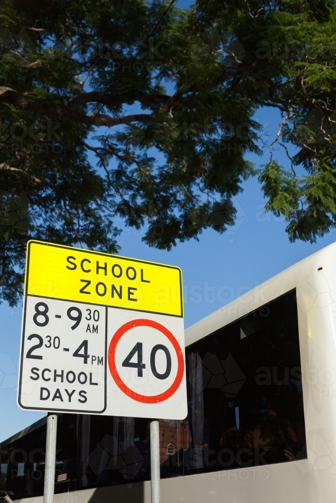 Bus next to school zone sign - Australian Stock Image