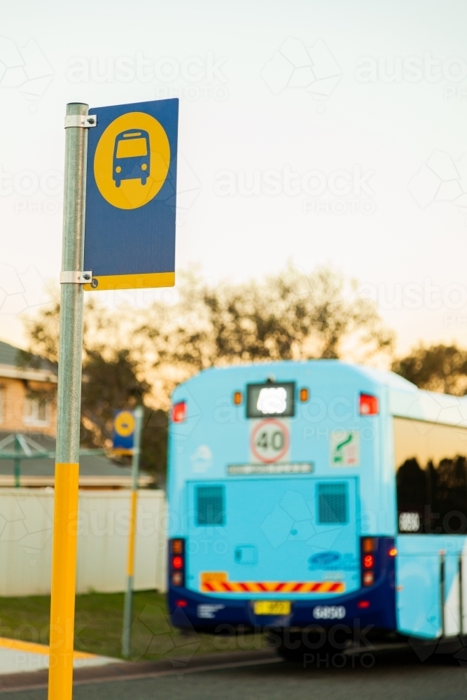 Bus stop sign and public transport bus - Australian Stock Image