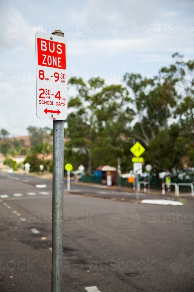 Bus zone sign near public school in town - Australian Stock Image
