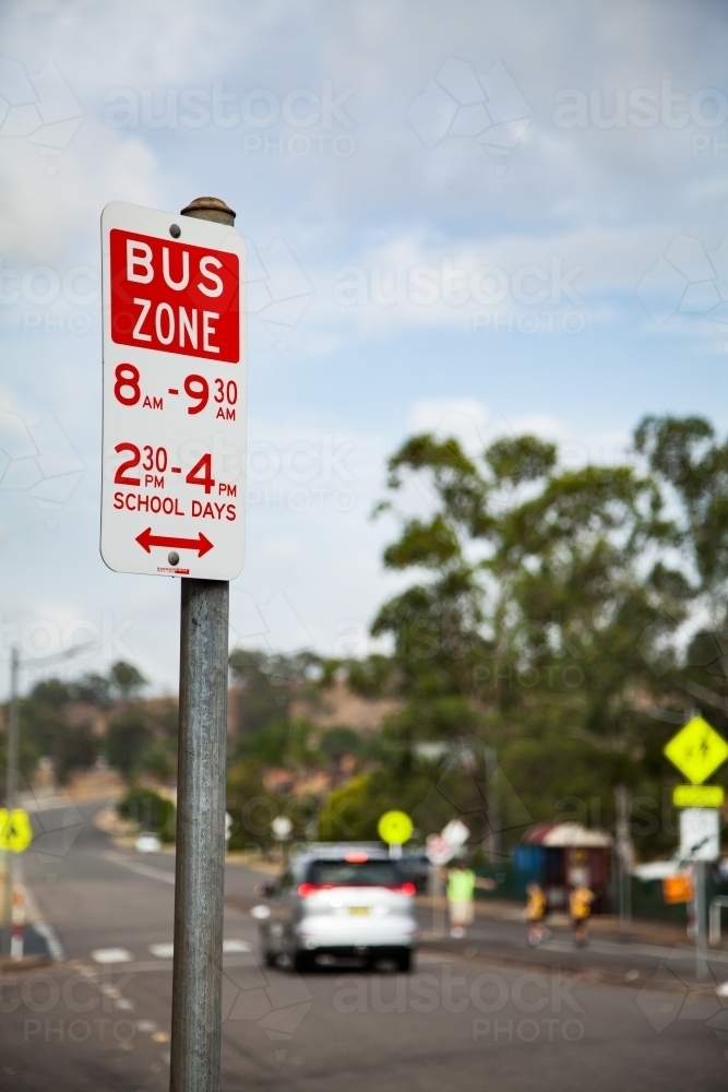 Bus zone sign near public school in town - Australian Stock Image