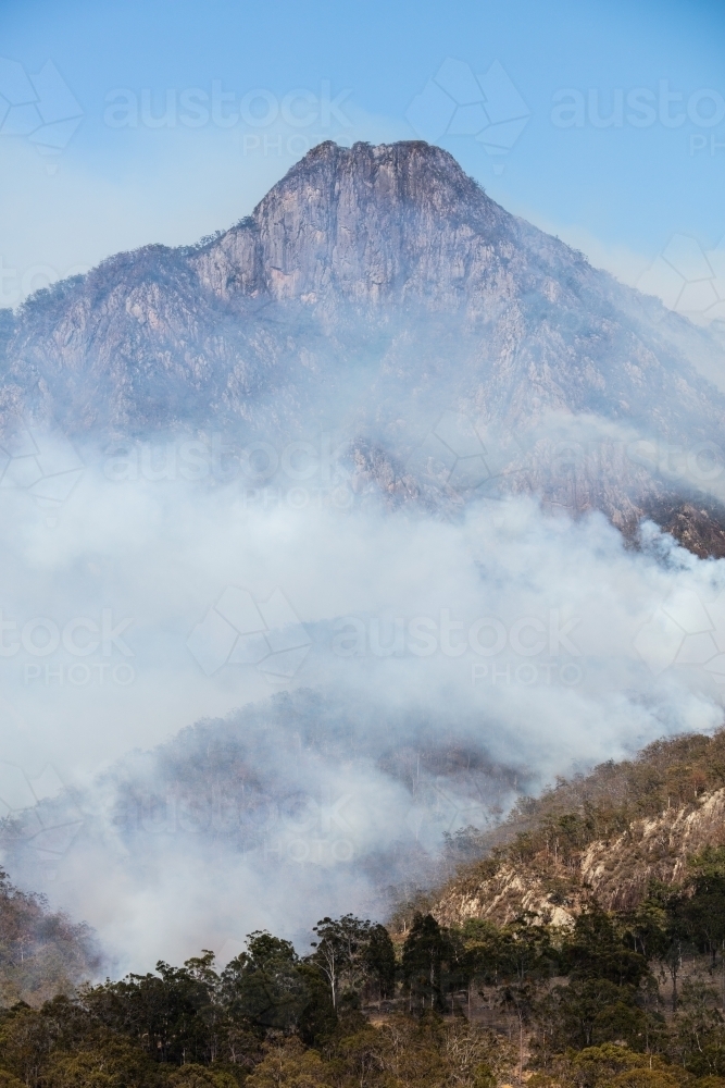 Bushfire smoke from a wildfire surrounds Mt Barney in the Scenic Rim. - Australian Stock Image