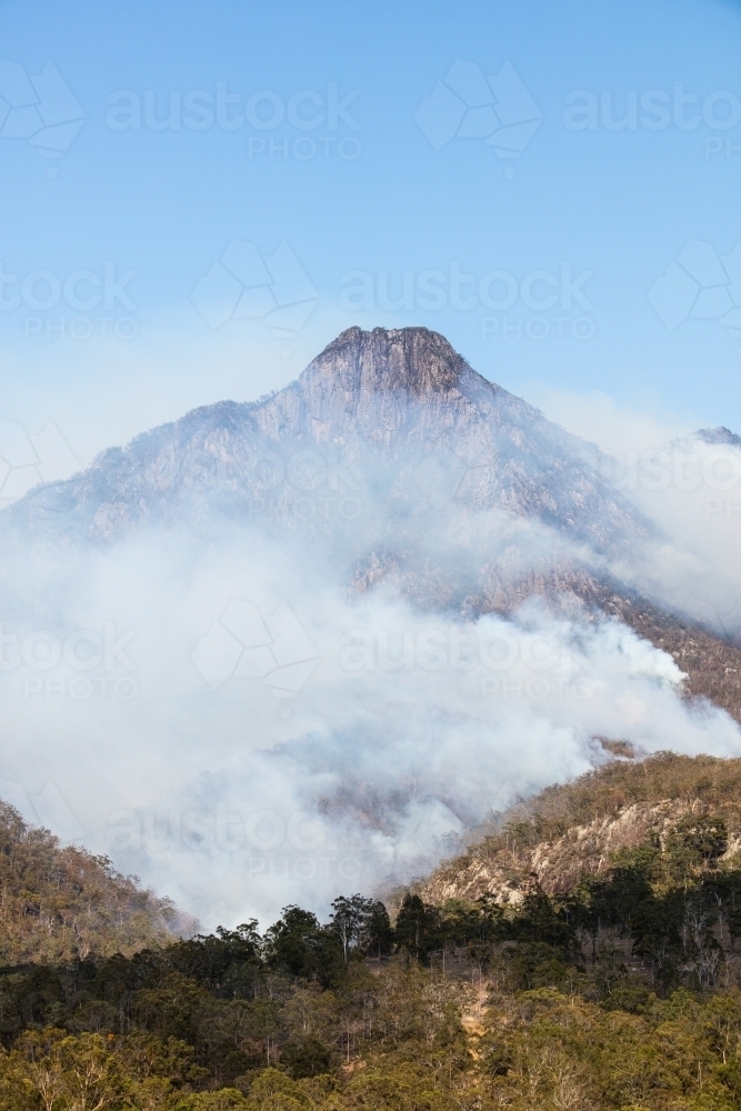 Bushfire smoke from a wildfire surrounds Mt Barney in the Scenic Rim. - Australian Stock Image