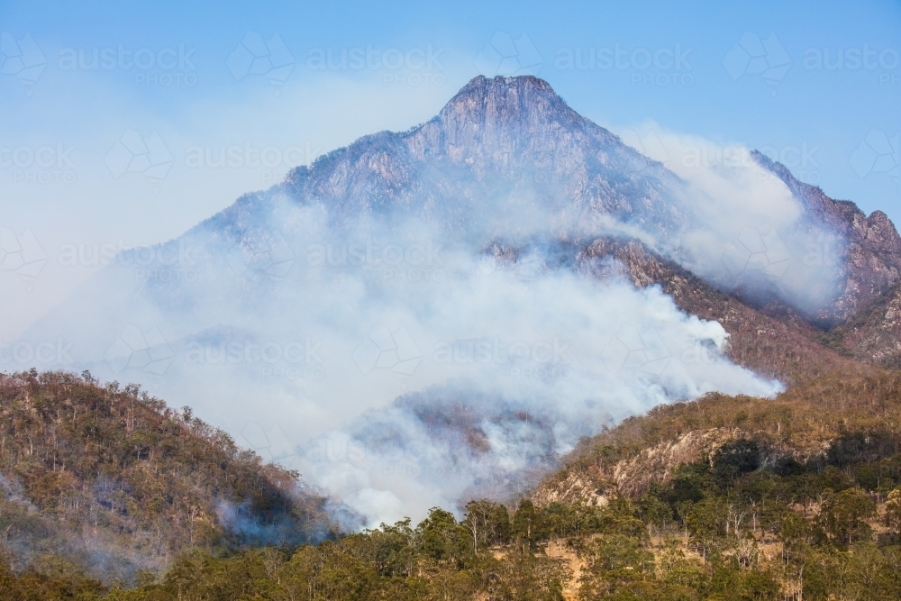 Bushfire smoke from a wildfire surrounds Mt Barney in the Scenic Rim. - Australian Stock Image