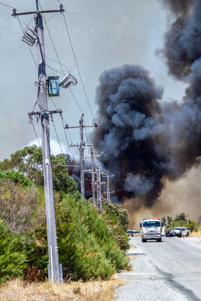 Bushfire with thick black smoke and emergency vehicles - Australian Stock Image