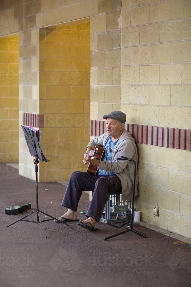 Busker playing guitar - Australian Stock Image