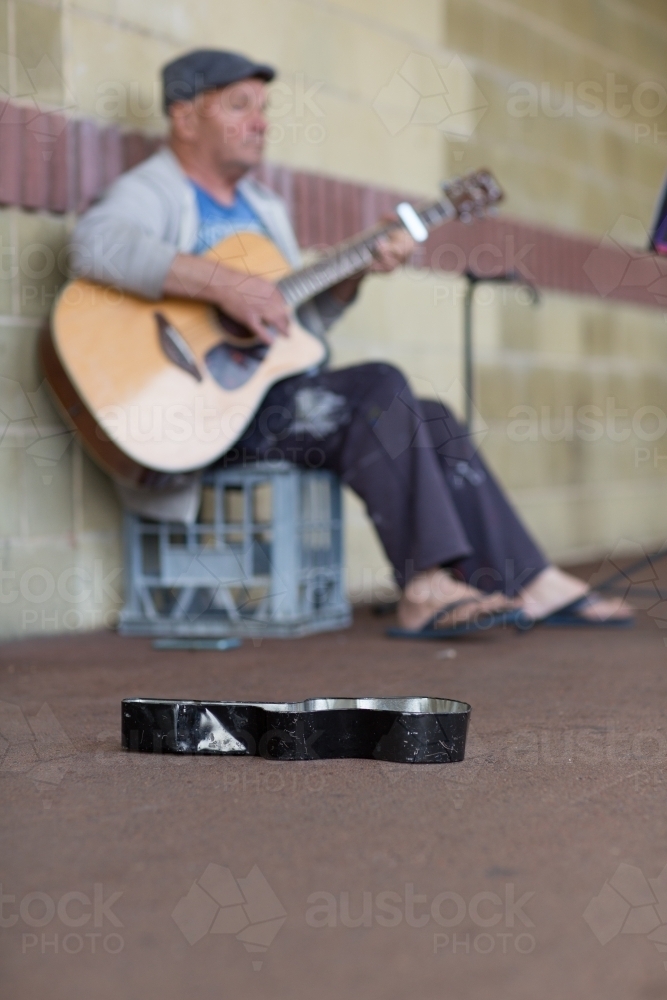 Busker playing guitar - Australian Stock Image
