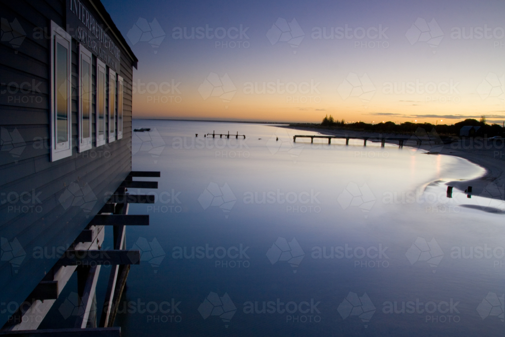 Busselton Jetty shimmers in the early morning in light in Busselton, Western Australia, Australia - Australian Stock Image