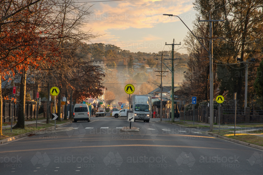 Image of Busy Small-Town Intersection at dawn - Austockphoto
