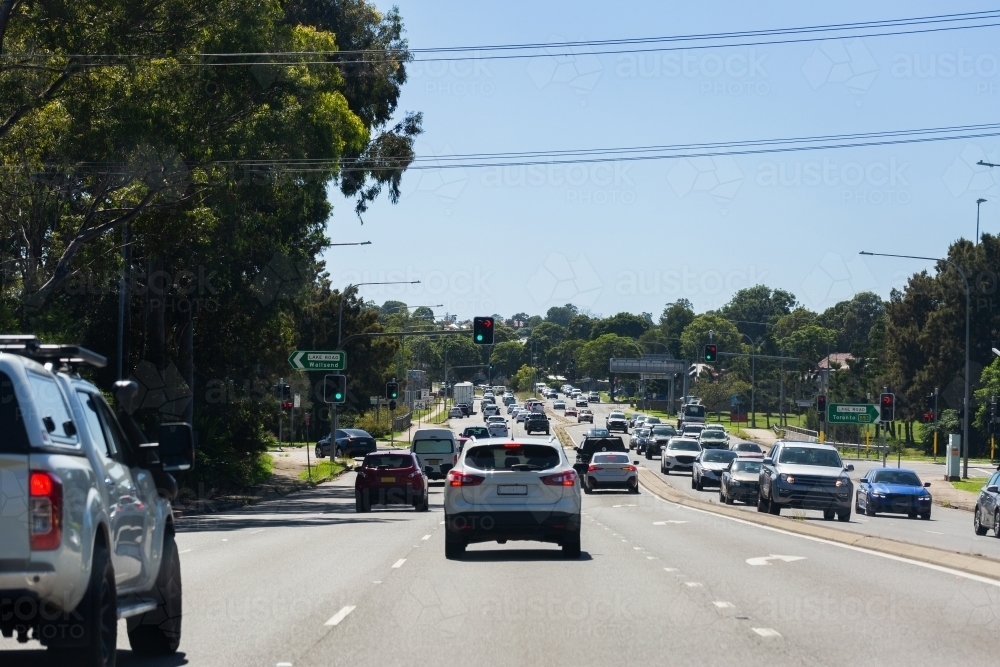 Busy traffic at intersection with traffic lights in city - Australian Stock Image