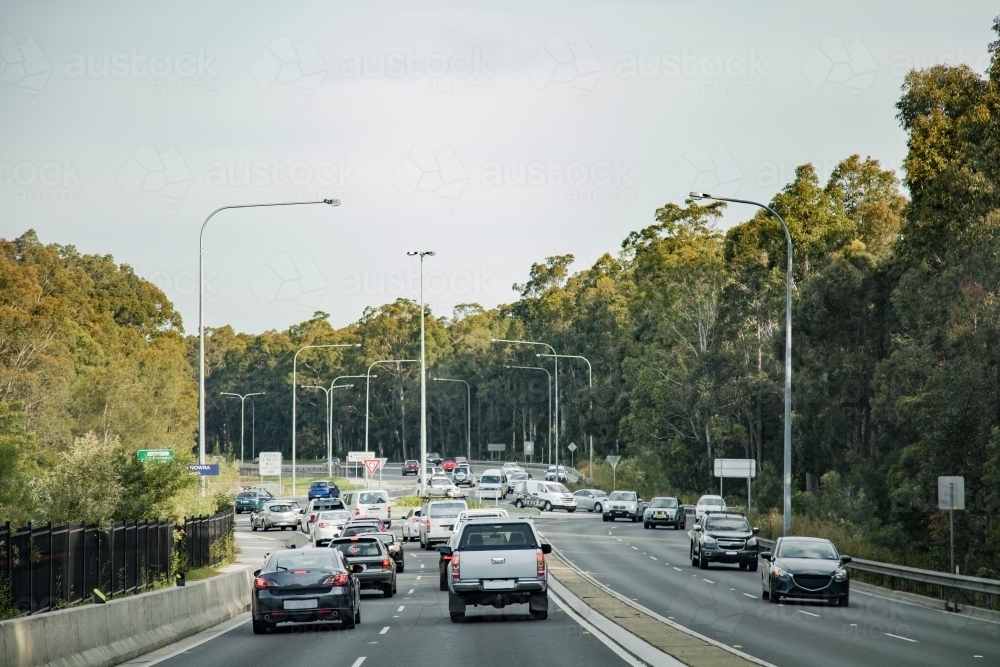 Busy traffic driving through a roundabout on a highway - Australian Stock Image