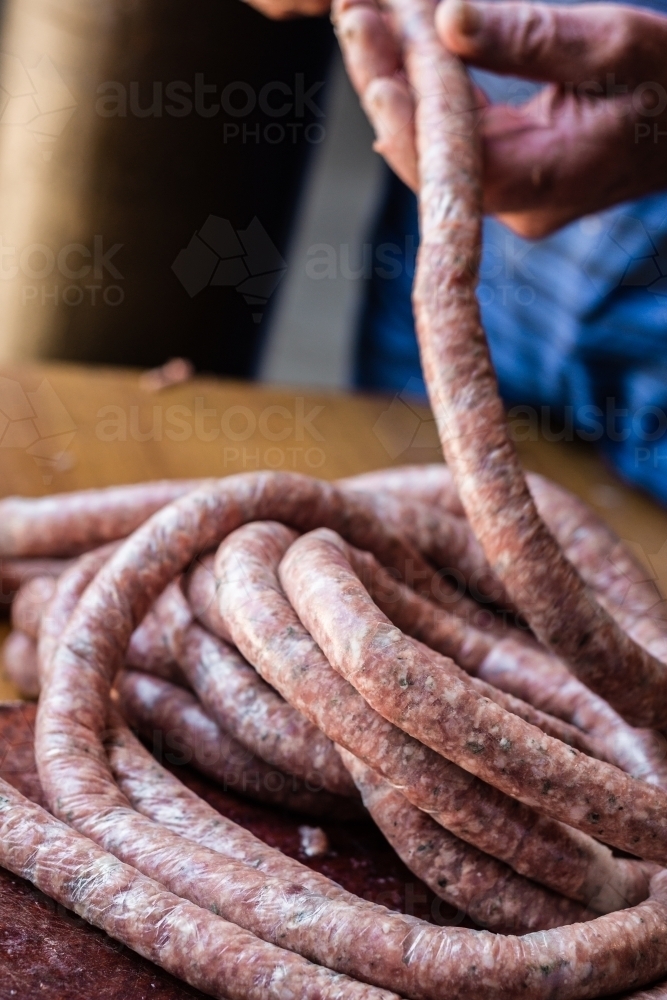 butcher making sausage links - Australian Stock Image