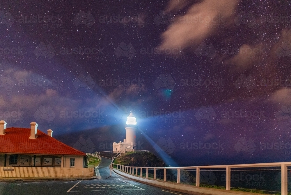Byron Bay Lighthouse at night shining among the stars. - Australian Stock Image