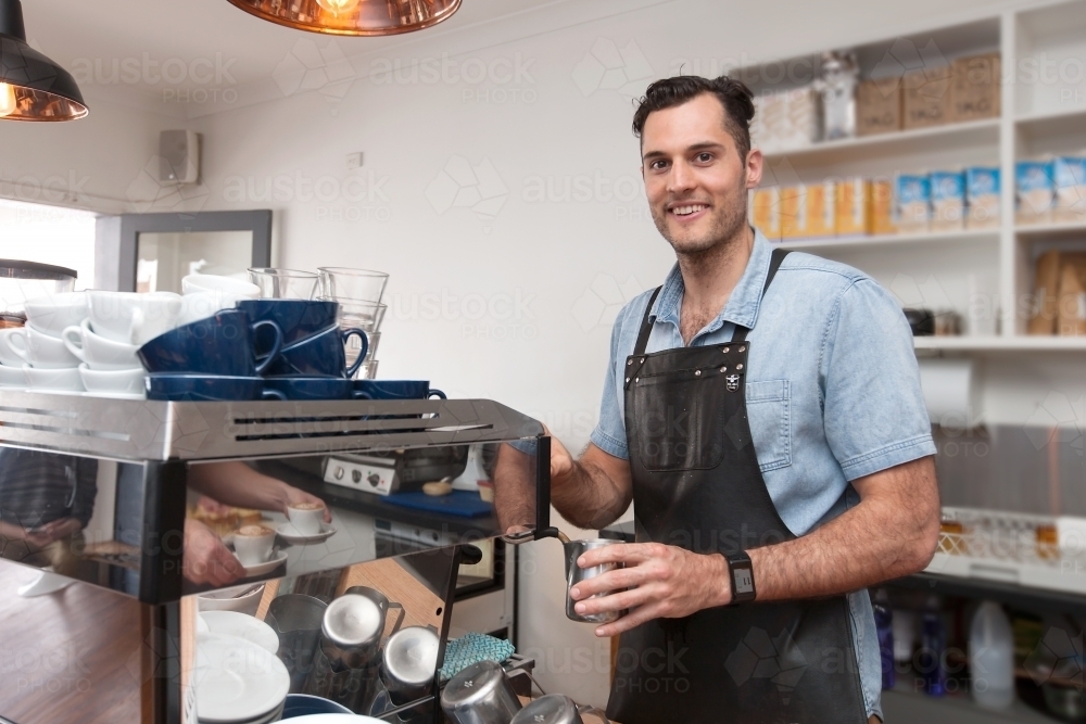 Cafe owner making coffee - Australian Stock Image