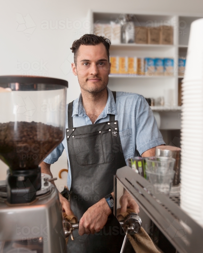 Cafe owner making coffee - Australian Stock Image