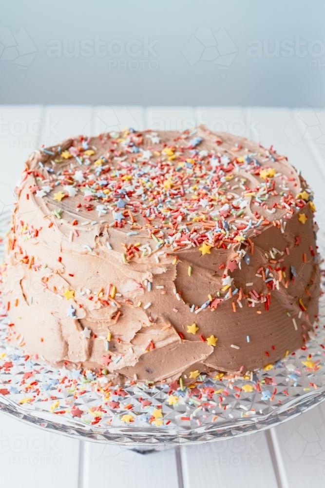 Cake with chocolate icing and sprinkles - Australian Stock Image