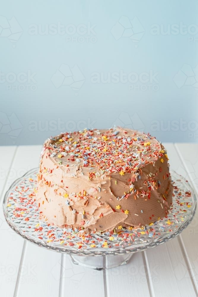 Cake with chocolate icing and sprinkles - Australian Stock Image
