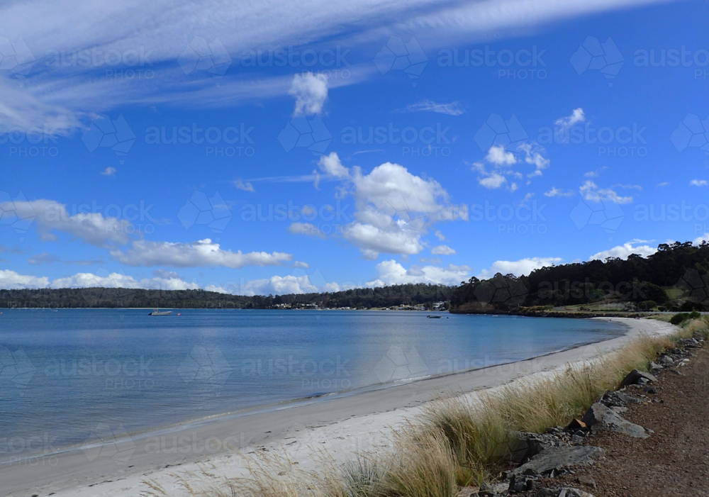 Calm bay with white sandy beach sunny day - Australian Stock Image