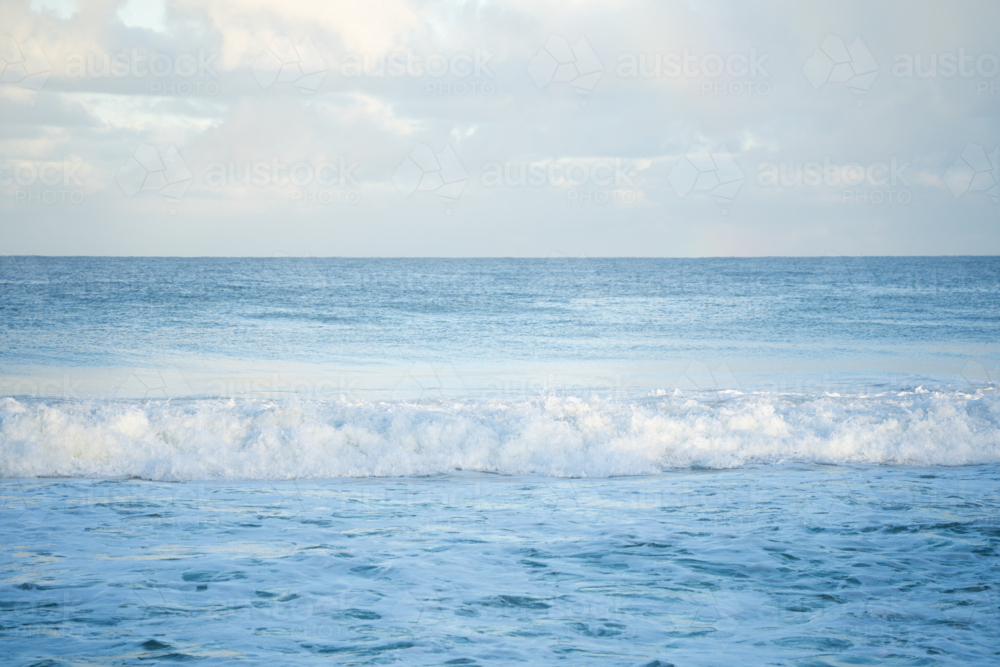 Calm open ocean water and blue sky horizon at Scarborough Beach, Perth, Western Australia - Australian Stock Image