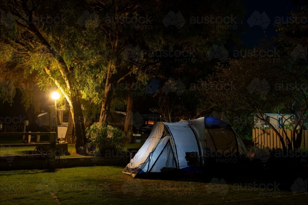 Campground tent illuminated at night. - Australian Stock Image