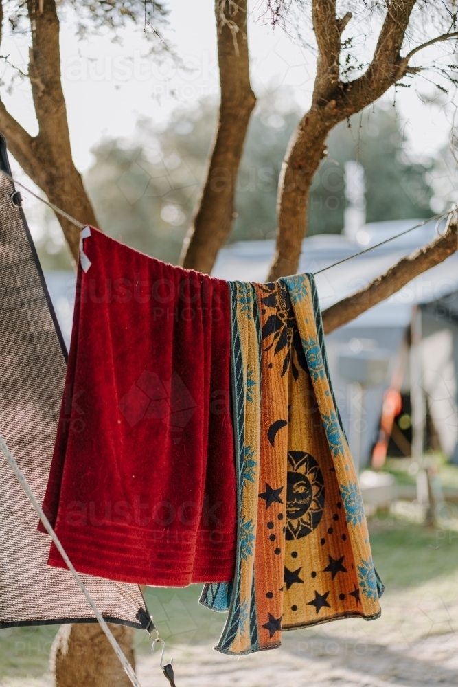 Camping towels hung on line in tree - Australian Stock Image