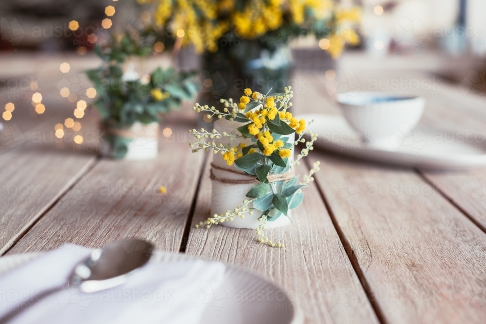 candle with wattle flower - Australian Stock Image