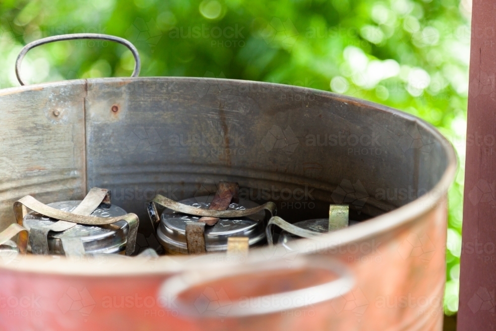 Canning jars in a boiling-water canner for preserving fruit - Australian Stock Image