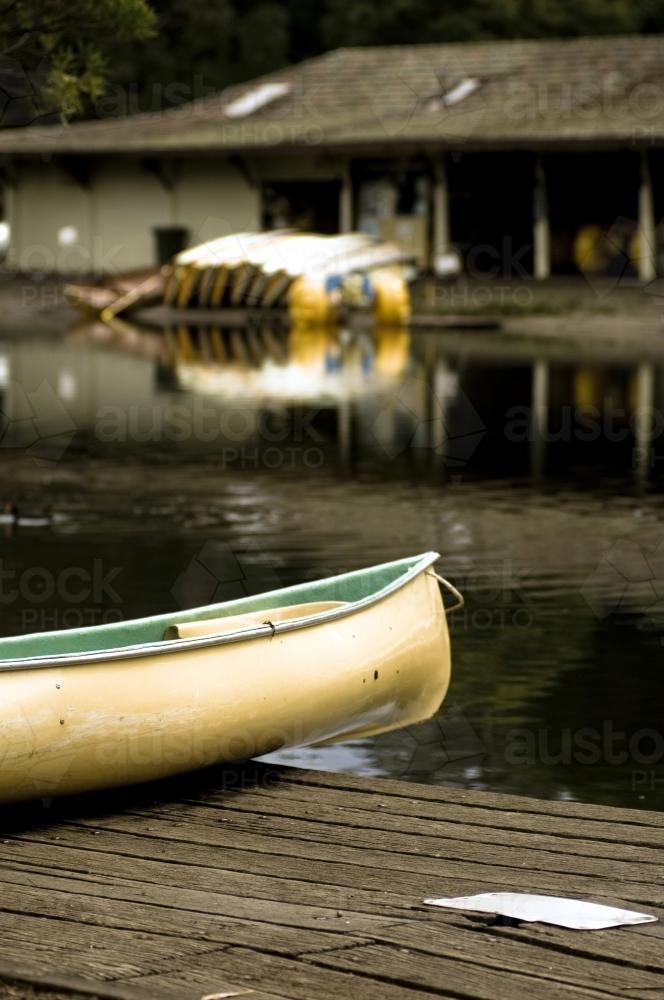 Canoe near boat shed with boats in back ground - Australian Stock Image