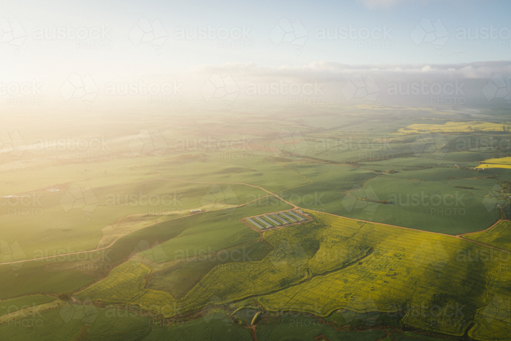Canola and farming landscape over the Avon Valley in Western Australia at sunrise - Australian Stock Image