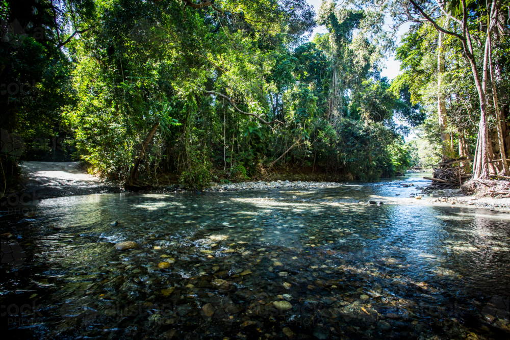 Cape Tribulation Rd which is 4WD only, crosses a river near Cape Tribulation in the Daintree - Australian Stock Image