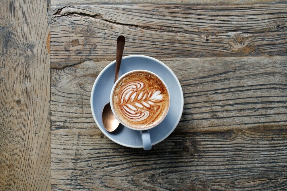 Cappuccino from above on a rustic wooden table with copy space - Australian Stock Image