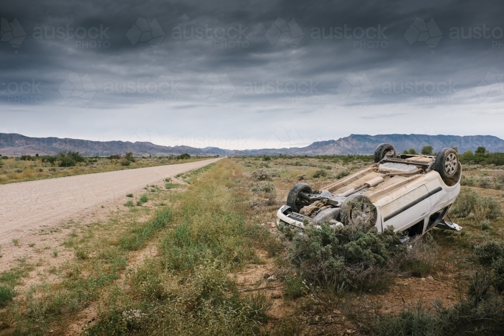 Car accident, a car rolled over after having an accident on a rural road - Australian Stock Image