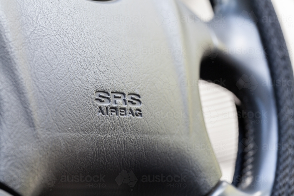 Car airbag on steering wheel close up macro shot - Australian Stock Image