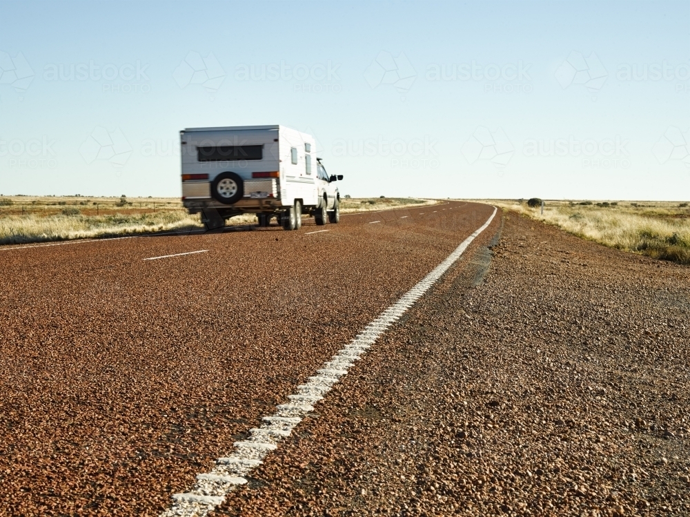 Car and caravan on Stuart Highway - Australian Stock Image
